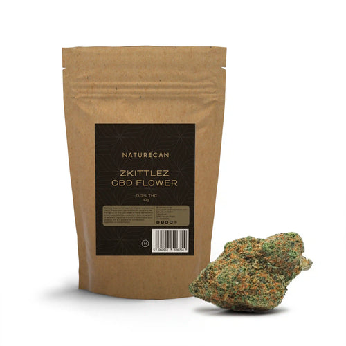 Naturecan Zkittlez CBD Flower – kraft paper resealable pouch 10g, 0.3% THC, with dense green and orange-trichome CBD flower bud beside it