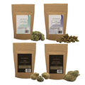 Four Naturecan CBD flower and CBD marijuana stand-up pouches arranged in a 2x2 grid, with loose green and orange-brown buds placed in front of each package on a plain white background.